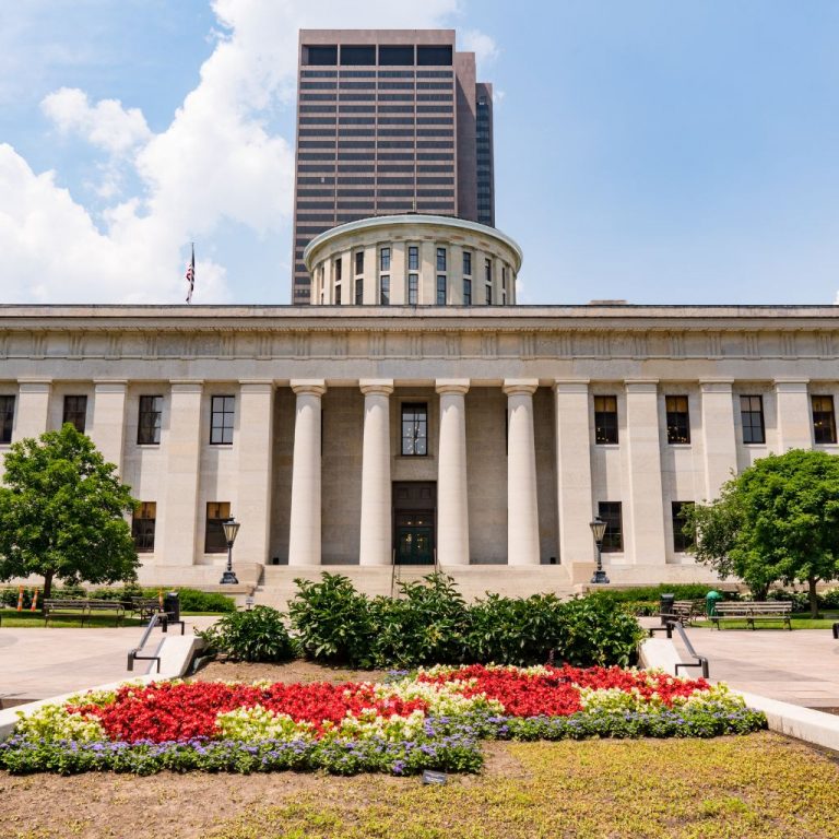Ohio state capital building sunny day and lots of flowers in the front.